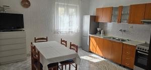 a kitchen with a table and a kitchen with a sink at Karmen 2 in Sveti Juraj