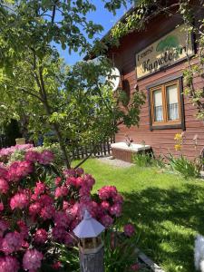 a house with pink flowers in front of it at Kameleon Dźwirzyno in Dźwirzyno
