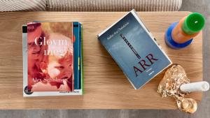 a book and a key chain on a table at Beitisstova - Mesmerizing Sea & Mountain Views in Stykkið +8 photos