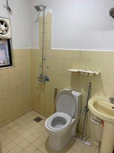 a bathroom with a toilet and a sink at Hillcrest Terraces Bhurban in Rāwāt +32 photos