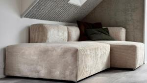 a living room with a couch and a chair at Beitisstova - Mesmerizing Sea & Mountain Views in Stykkið