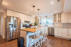 a kitchen with a refrigerator and a table with chairs at 72 S Orem Entire Home in Orem