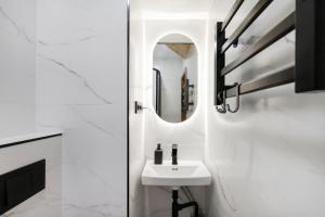 a bathroom with a sink and a mirror at House of Sun in Vilnius +150 photos