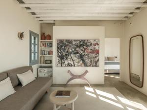 a living room with a couch and a painting on the wall at Verina Astra in Artemonas