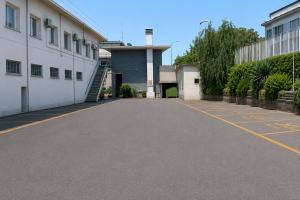 an empty parking lot in front of a building at Lh HOTELS in Milan