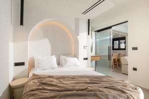 a bedroom with a large bed with an arch above it at Ciel Seafront Suites - Lefkada in Lygia +39 photos