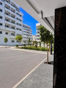 an empty street in front of a building at Modern Comfort Stay Tanger in Tangier