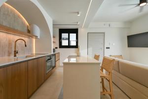 a kitchen with a sink and a counter top at Ciel Seafront Suites - Lefkada in Lygia