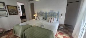 a bedroom with a bed and two pillows on it at Georgesville in Marbella