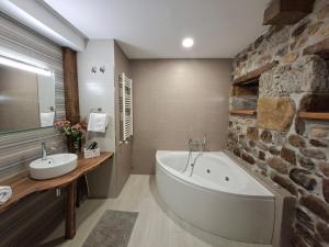 a bathroom with a large tub and a sink at La Capital del Mundo in Arredondo +28 photos