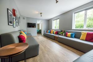 a living room with couches and a table at Big Lodge in Peebles