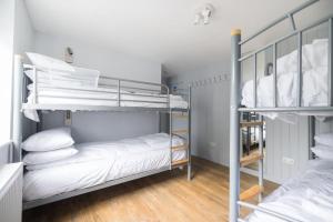 two bunk beds in a room with wooden floors at Big Lodge in Peebles