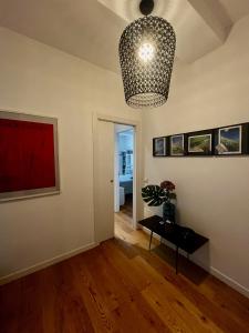 a living room with a pendant light and a table at Sunset Suite in Laveno-Mombello