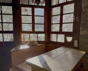 a room with four windows and a bench in front of it at Le Mazot des Révines - 2 pers in Champéry