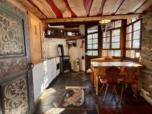 a kitchen with a wooden table and a tableasteryasteryasteryasteryasteryasteryastery at Le Mazot des Révines - 2 pers in Champéry