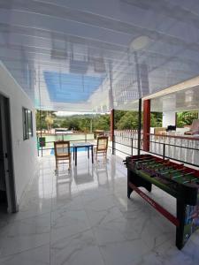 a room with a ping pong table and chairs at Finca Fusagasugá Villa Luisa in Fusagasuga