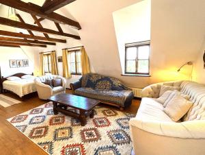 a living room with two couches and a coffee table at Casa Cojo in Sighişoara