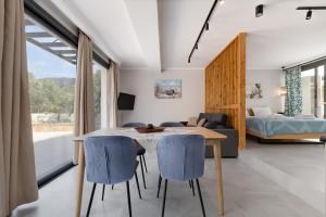 a room with a table and chairs and a bedroom at Villa Ilianthi in Kalamitsi