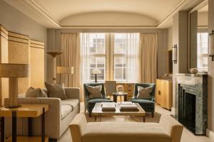 a living room with a couch and a fireplace at Claridge's, Maybourne in London +98 photos