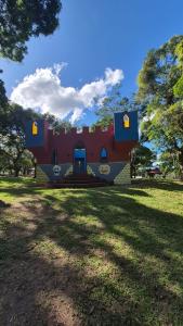 a red building with yellow doors in a park at Casa c ar cond, wifi, a 5 min Orla da Lagoa Para Famílias in Araruama +69 photos