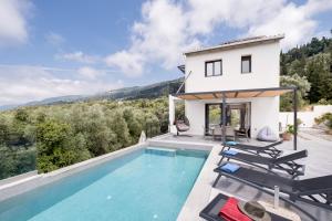 a villa with a swimming pool and a house at Villa Ilianthi in Kalamitsi