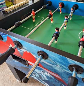 a ping pong table with people playing a game at Bed and Breakfast Lek & Jo in Suchy