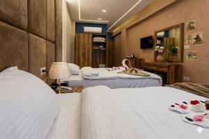 a hotel room with three beds and a mirror at khofo pyramids view in Cairo
