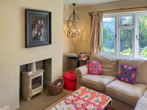 a living room with a couch and a fireplace at St Anthonys in Ampleforth