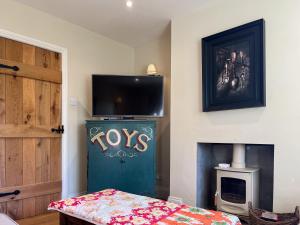 a room with a green door with tvs on the wall at St Anthonys in Ampleforth