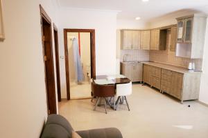 a kitchen with a table and some chairs in it at The Apartments By Sedrah in Irbid