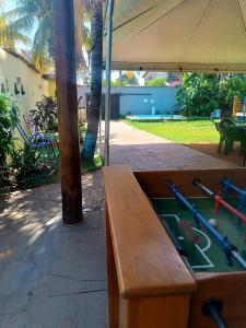 a ping pong table under a tent in a yard at Casa com Natureza in Goiânia
