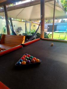 a pool table with a tray of balls on it at Casa com Natureza in Goiânia +1 photo