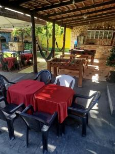 a table and chairs with a red table cloth on a patio at Casa com Natureza in Goiânia