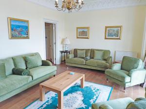 a living room with two couches and a coffee table at The Captains House in Instow