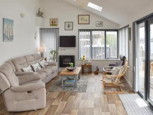 a living room with a couch and a table at Evening Glory in Brundall