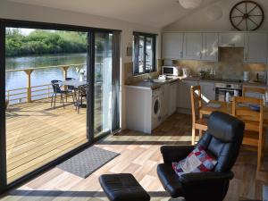 a kitchen and living room with a view of a deck at Evening Glory in Brundall