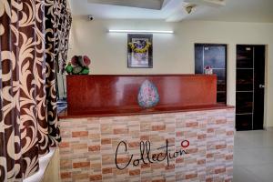 a bar in a room with a sign that says collector at Hotel O Konark Inn in Naroda