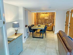 a dining room and living room with a table and chairs at Cosy Cottage in Portinscale