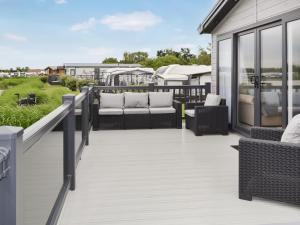 a patio with couches and chairs on a house at Sandy Shore - Uk37724 in Ingoldmells