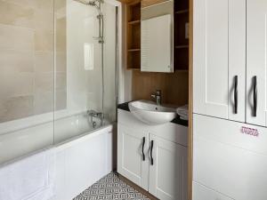 a bathroom with a sink and a tub and a toilet at Sandy Shore - Uk37724 in Ingoldmells