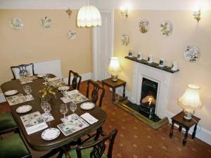 a dining room with a table and a fireplace at South Bay Cottage in Saasaig +15 photos