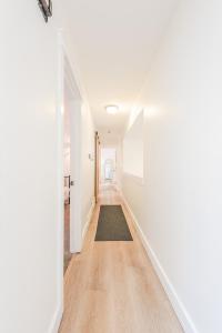 an empty hallway with white walls and a rug at 72 S Orem Upstairs Only in Orem +42 photos