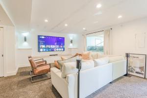 a living room with a white couch and a tv at 72 S Orem Upstairs Only in Orem