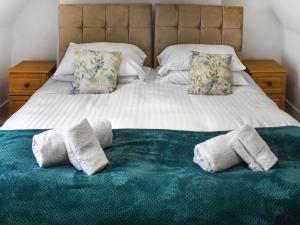 a bed with two pillows on top of it at The Farmhouse - Uk50909 in Thornhaugh +14 photos