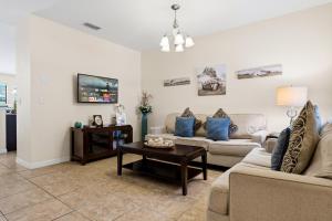a living room with two couches and a coffee table at Family Friendly - South Facing Pool - Game Room - Gated - Near Disney in Davenport