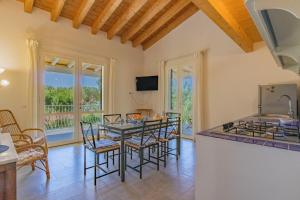 a kitchen and dining room with a table and chairs at Villa Artistica in Trappola
