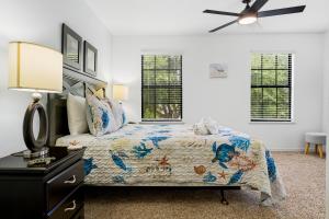a bedroom with a bed and a ceiling fan at Family Friendly - South Facing Pool - Game Room - Gated - Near Disney in Davenport +48 photos