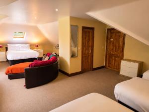 a hotel room with two beds and a couch at Moorepark West House in Fermoy