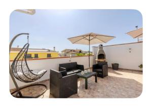 a patio with a hammock and a couch and an umbrella at Incanto patio house in Sestu
