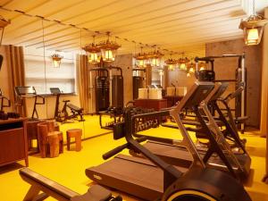 a gym with several exercise equipment in a room at Mondrian Bordeaux Les Carmes in Bordeaux